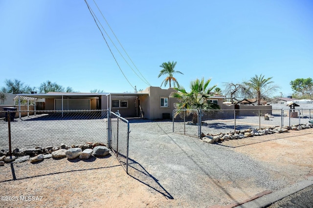 view of front facade featuring fence private yard, a gate, and stucco siding