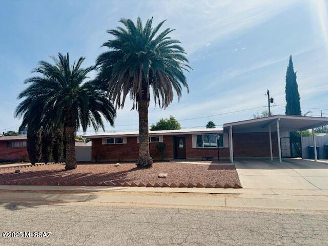 single story home with a carport and concrete driveway