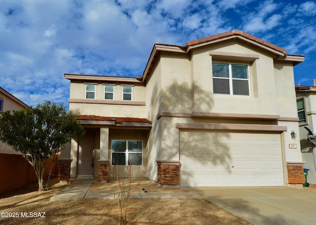 view of front facade with driveway, stone siding, an attached garage, and stucco siding