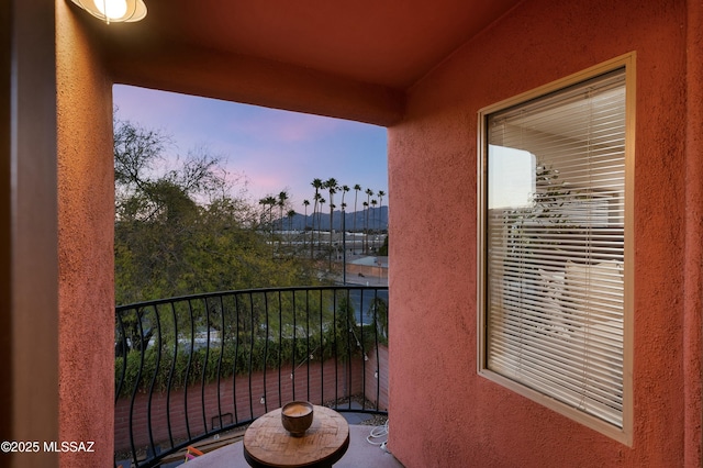 view of balcony at dusk