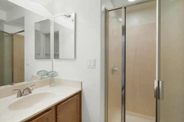 bathroom with a stall shower and vanity