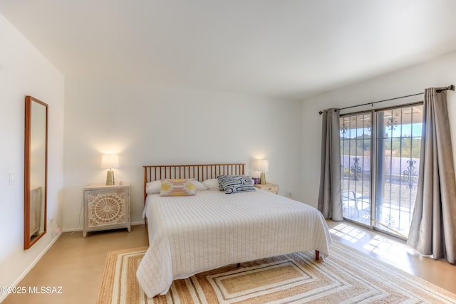 bedroom featuring access to outside and baseboards