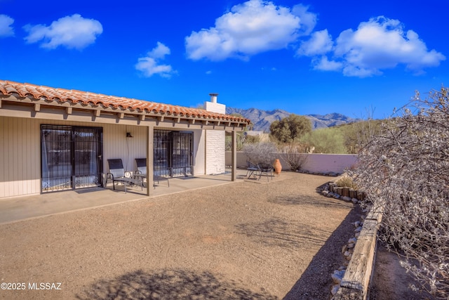 view of yard featuring a patio area and a mountain view