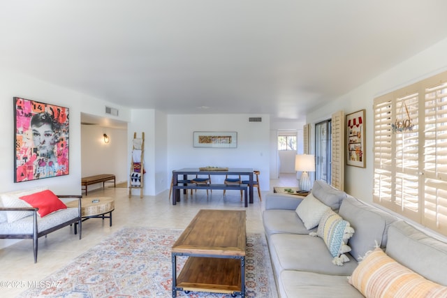 living room featuring light tile patterned floors and visible vents