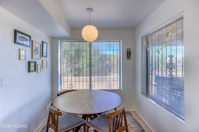 dining room with light tile patterned flooring and baseboards