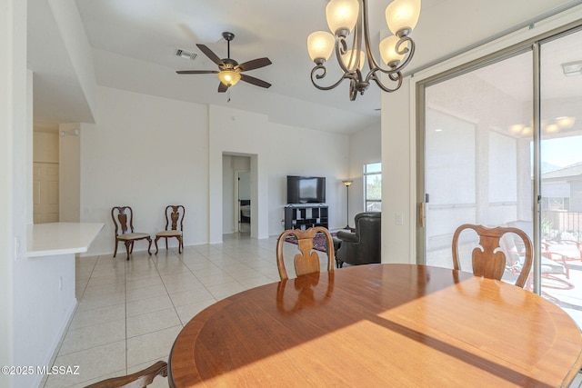 dining room with light tile patterned floors, ceiling fan with notable chandelier, and visible vents