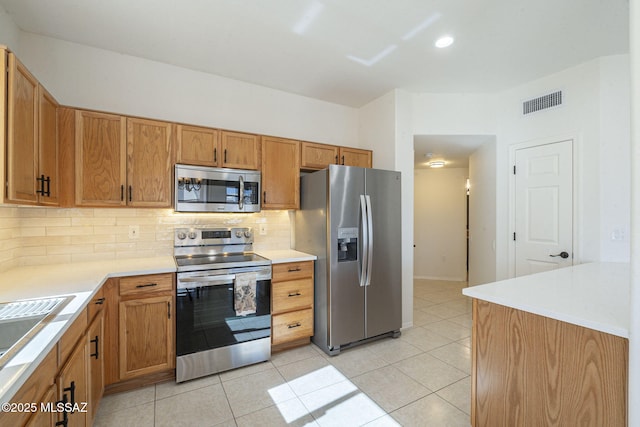 4751 S Longmore Dr, Green Valley, AZ 85622 - kitchen featuring tasteful backsplash, visible vents, appliances with stainless steel finishes, light tile patterned flooring, and light countertops