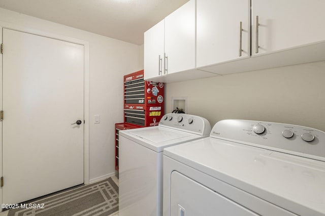 washroom with washing machine and dryer and cabinet space