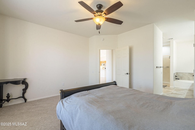 bedroom with light carpet, ensuite bath, a ceiling fan, and baseboards