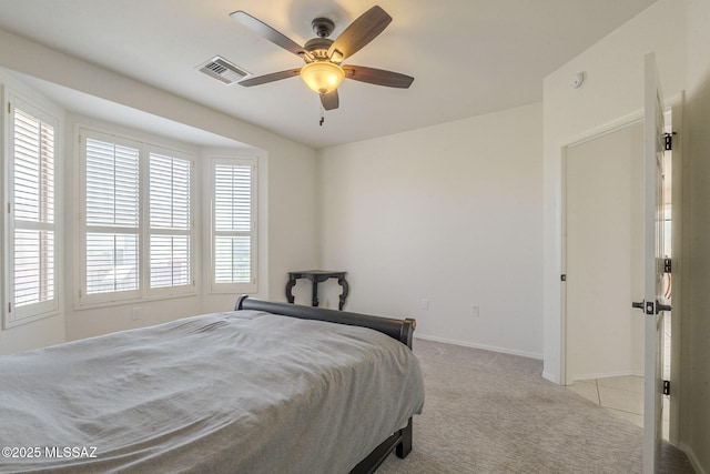 bedroom featuring light carpet, ceiling fan, visible vents, and baseboards