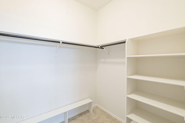 spacious closet with tile patterned floors