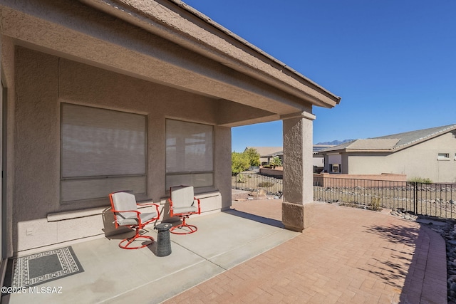 view of patio / terrace featuring fence and a residential view