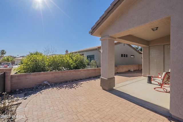 view of patio featuring fence