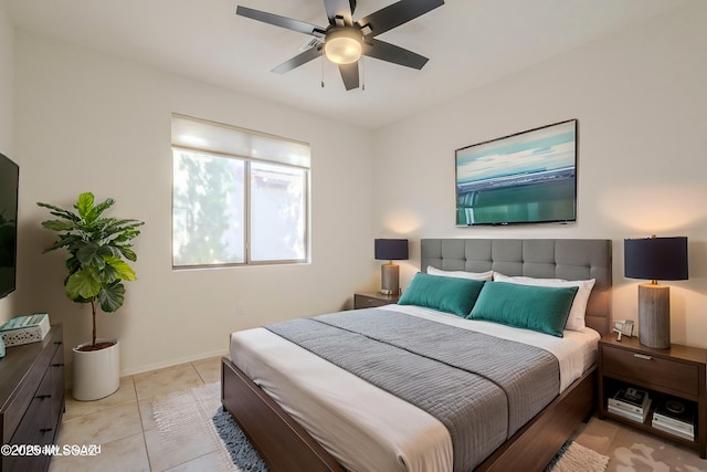 bedroom featuring ceiling fan, baseboards, and light tile patterned floors