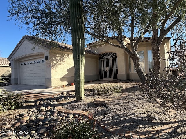 view of side of property with an attached garage and stucco siding