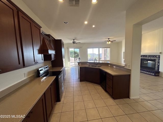 kitchen with black dishwasher, light tile patterned floors, visible vents, stainless steel range with electric cooktop, and a sink