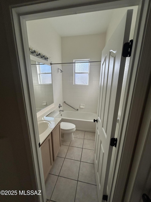 full bath with washtub / shower combination, vanity, toilet, and tile patterned floors