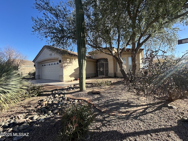 view of front of home featuring a garage, a tile roof, and stucco siding