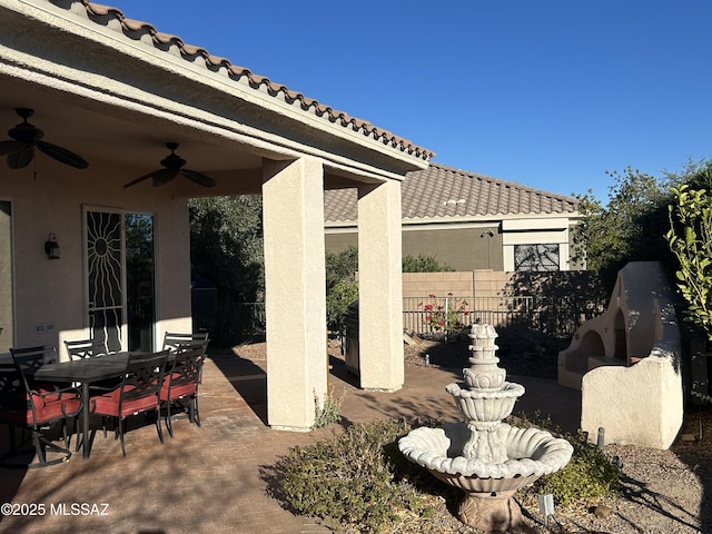 view of patio featuring fence, a ceiling fan, and outdoor dining space