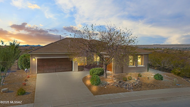 1432 E Lower Mine Ln, Sahuarita, AZ 85629 - view of front of home with driveway, an attached garage, and stucco siding