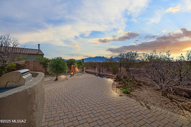 view of patio / terrace featuring a fenced backyard and a mountain view