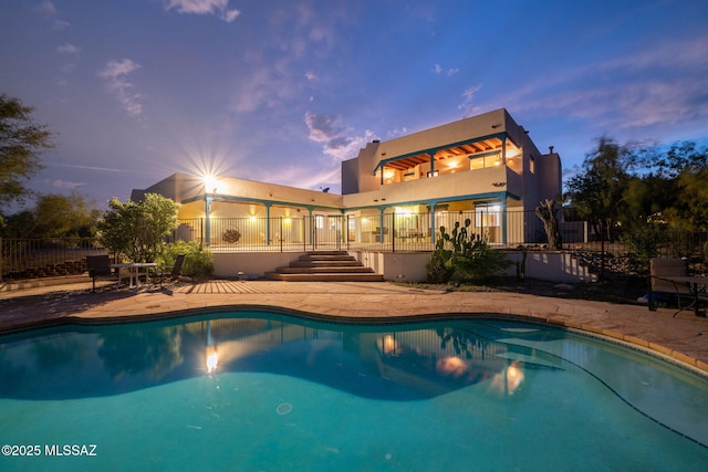 pool featuring a patio area and fence