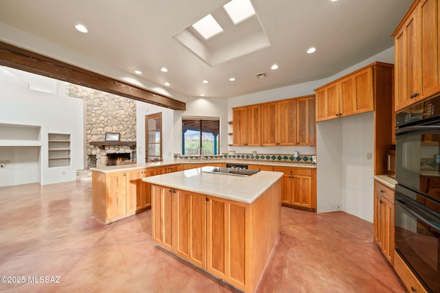 kitchen with a center island, a fireplace, recessed lighting, visible vents, and a peninsula