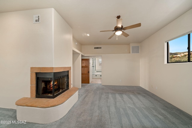 unfurnished living room featuring carpet, visible vents, and a multi sided fireplace