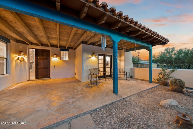 patio terrace at dusk with fence and french doors