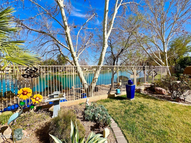 view of yard with a water view and fence