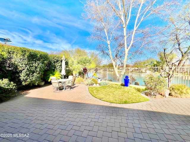 view of patio with outdoor dining space and fence