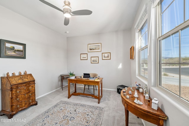 office with light carpet, a ceiling fan, and baseboards