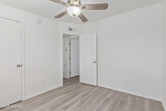 unfurnished bedroom with a ceiling fan, baseboards, visible vents, and light wood finished floors