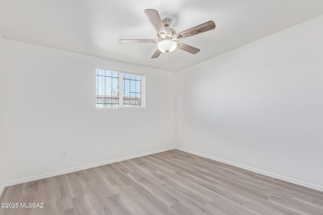 empty room with a ceiling fan, baseboards, and light wood finished floors