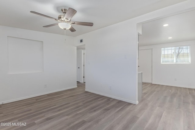 unfurnished room featuring a ceiling fan, recessed lighting, light wood-style flooring, and baseboards