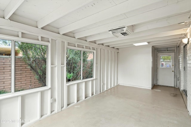 unfurnished sunroom featuring beamed ceiling and visible vents