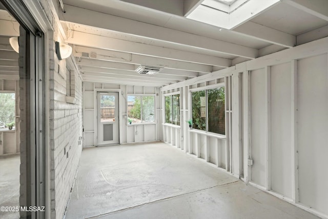 unfurnished sunroom with a skylight