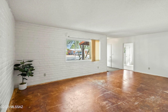 unfurnished room featuring concrete floors and a textured ceiling