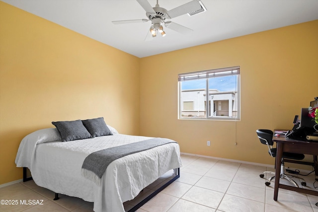 bedroom with a ceiling fan, light tile patterned floors, and baseboards