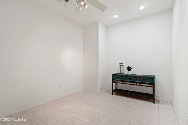 spare room with light tile patterned floors, baseboards, ceiling fan, and visible vents