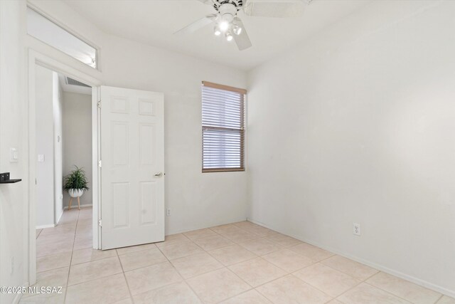 unfurnished room with a ceiling fan, light tile patterned flooring, and visible vents