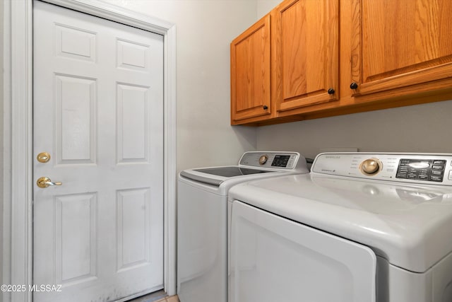 laundry area featuring cabinet space and separate washer and dryer