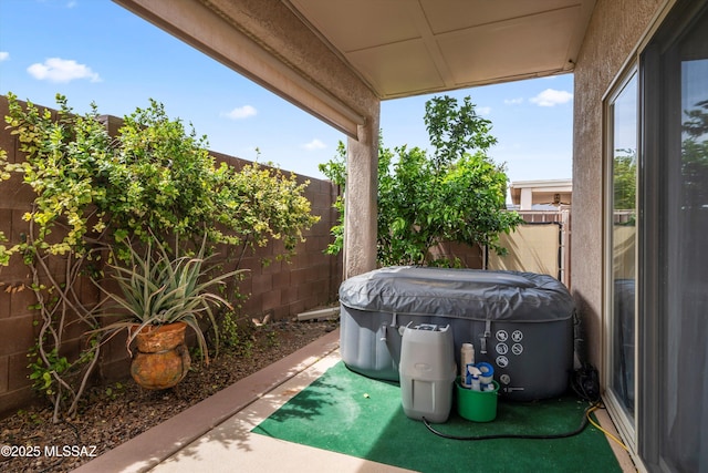 view of patio / terrace with a jacuzzi and a fenced backyard