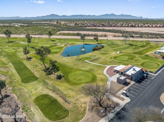 drone / aerial view featuring view of golf course and a water and mountain view
