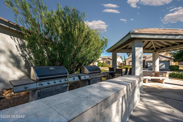 view of patio featuring area for grilling and a gazebo