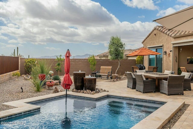 view of swimming pool featuring a fire pit, a patio, and a fenced backyard