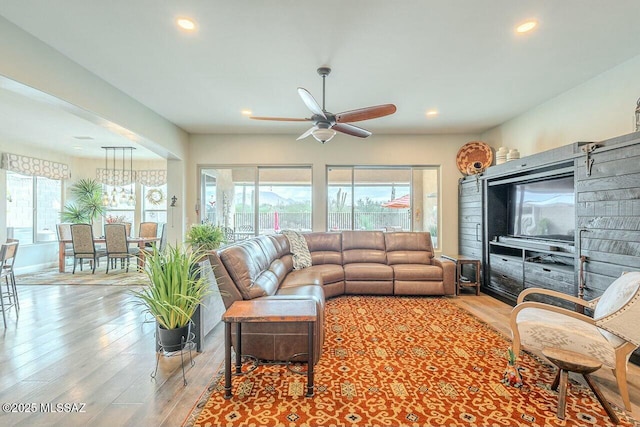 living area featuring a ceiling fan, recessed lighting, and wood finished floors