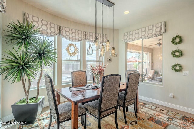 dining space featuring wood finished floors and baseboards