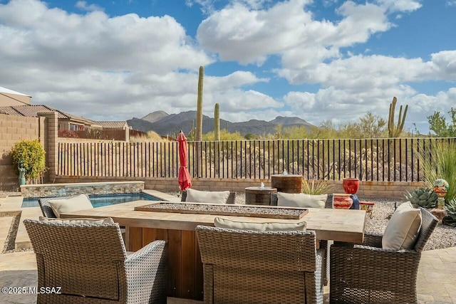 view of patio featuring a fenced backyard and a mountain view