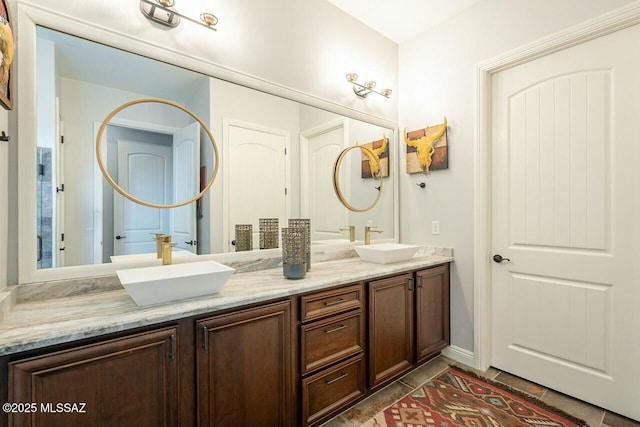 full bathroom featuring double vanity and a sink